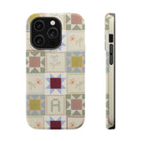 Patchwork personalized iPhone case featuring a multicolored quilt design with various geometric patterns.
