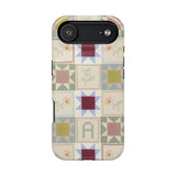 Patchwork personalized iPhone case featuring a colorful quilt design with various geometric patterns and soft pastel colors.