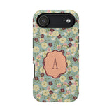 Personalized iPhone case featuring a floral pattern with a central monogrammed letter "A" on a light blue background.