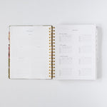 2026 Meadow Weekly Planner open to pages featuring monthly overview and habit tracker sections with blank spaces.