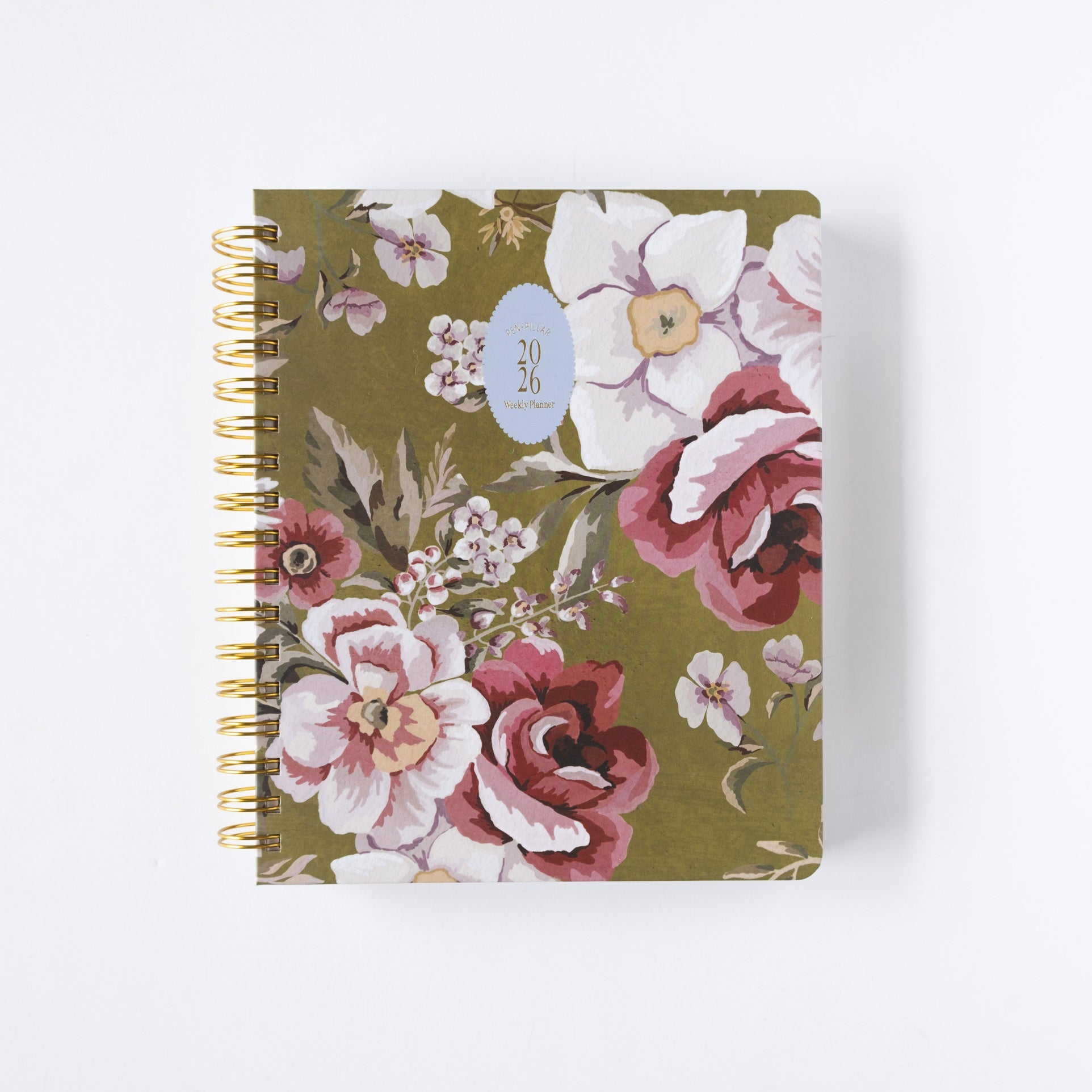 2026 Meadow Weekly Planner with floral design in pink and white on an olive green background, featuring a gold spiral bind...