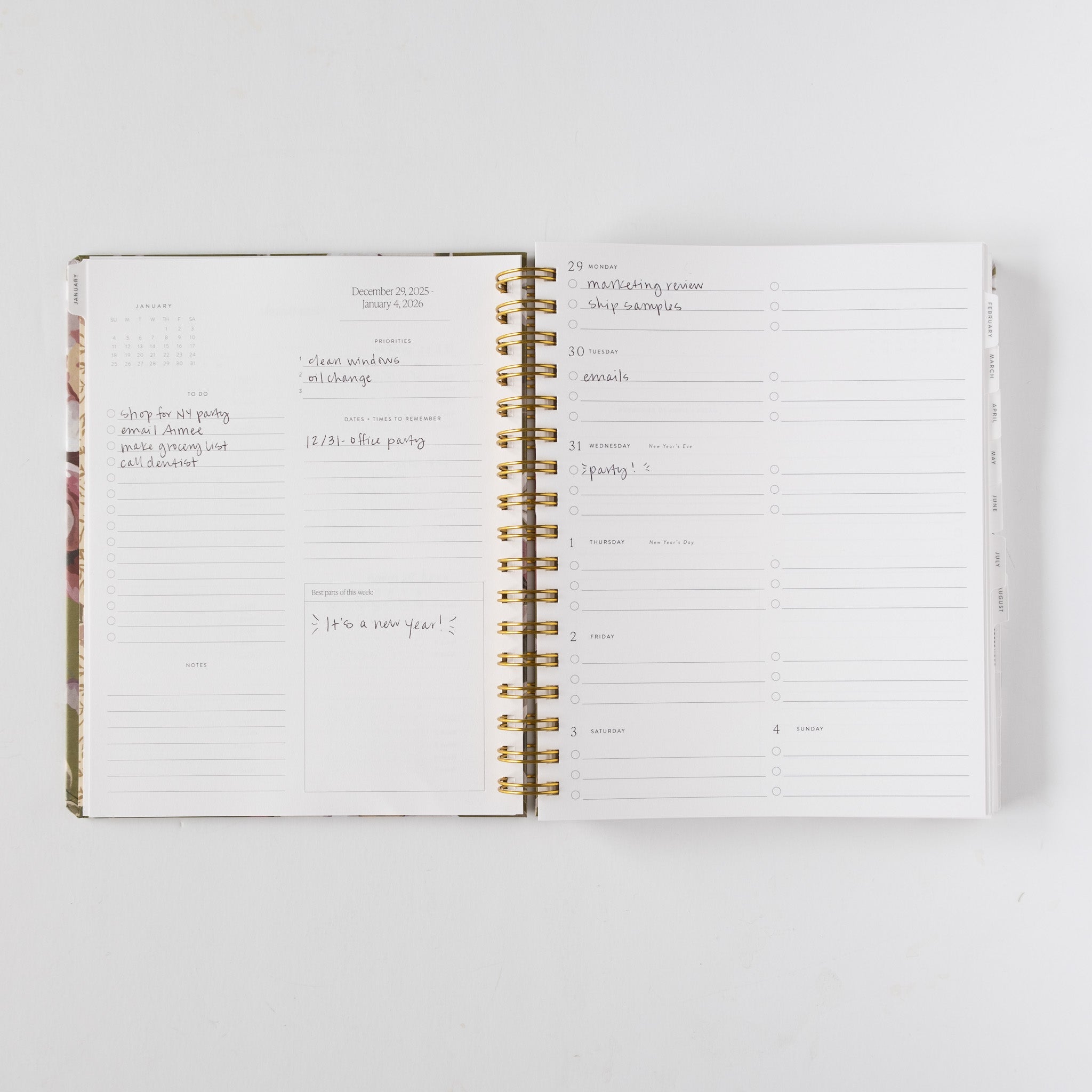 2026 Meadow Weekly Planner open to a week view, featuring floral design, gold spiral binding, and handwritten notes.