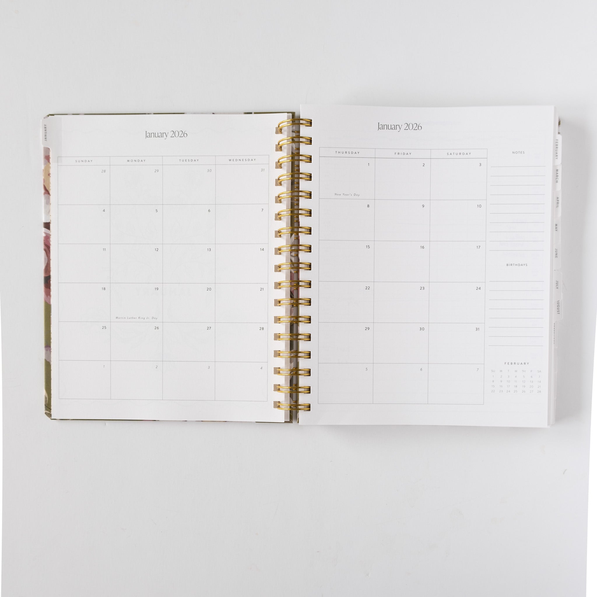 2026 Meadow Weekly Planner opened to January 2026, featuring blank monthly calendar pages and gold spiral binding.