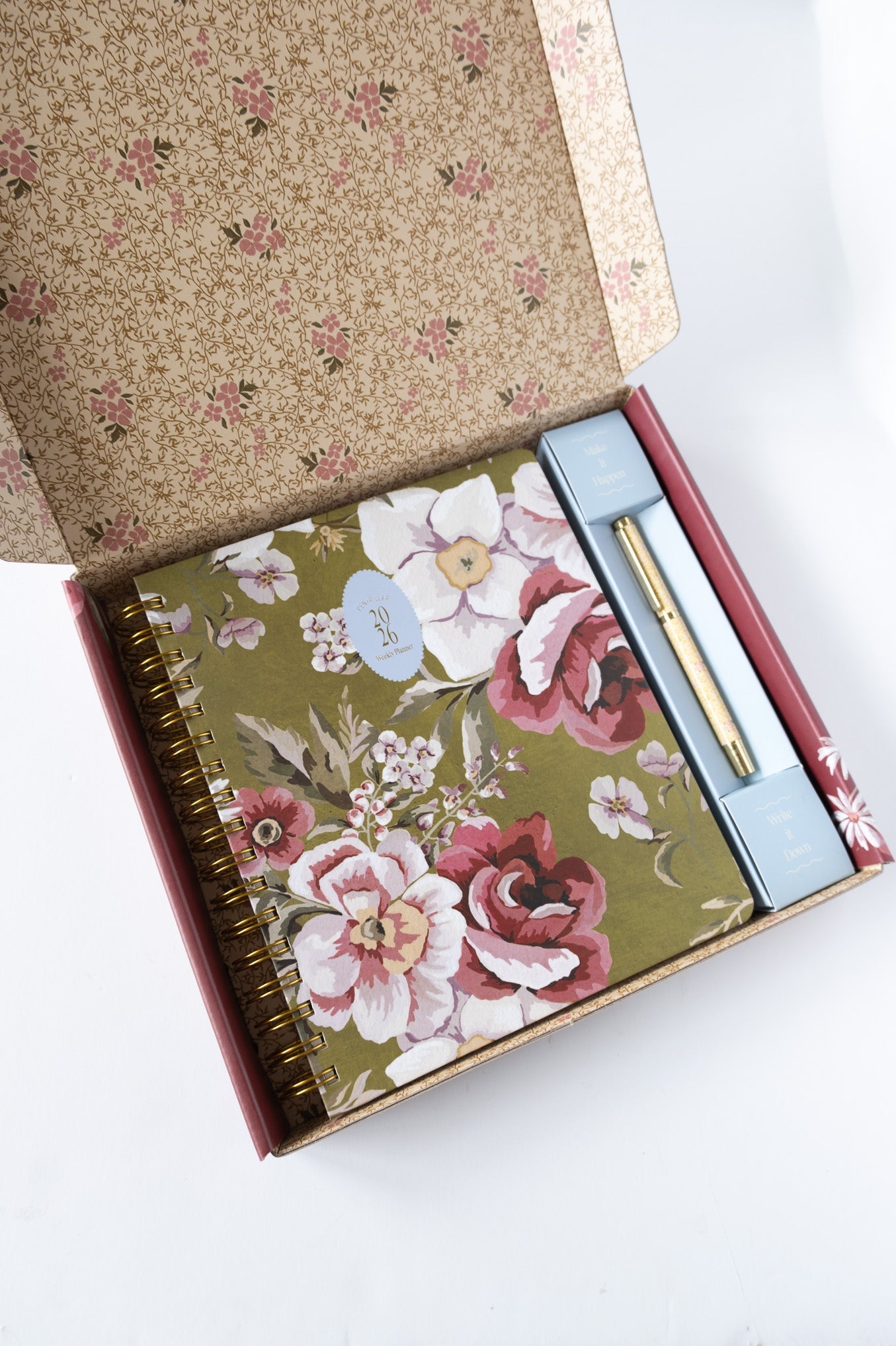 2026 planner bundle featuring a floral cover, gold spiral binding, and a matching pen in a decorative box.