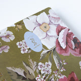 2026 planner bundle featuring a floral design with roses and white flowers on a green background.