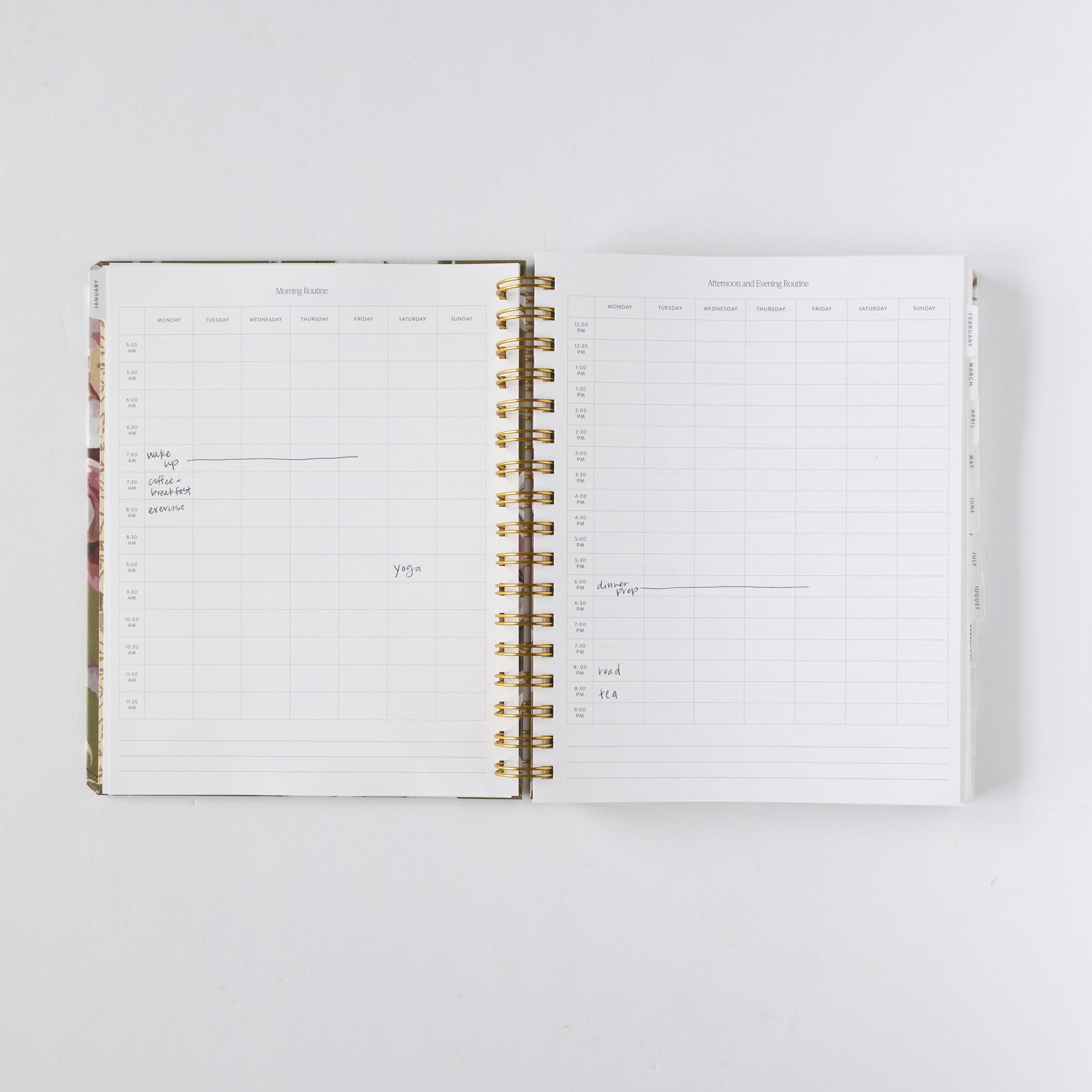 2026 planner bundle open to a weekly layout with gold spiral binding and floral cover design.