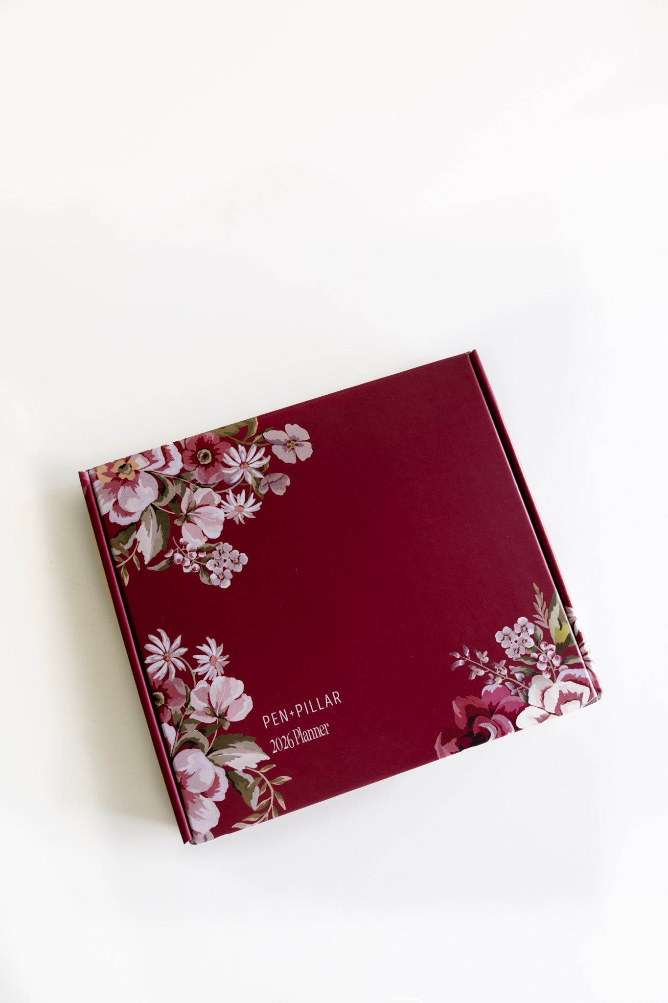 2026 planner bundle in a burgundy box with floral design on the front, featuring the text "Pen-Pillar 2026 Planner.