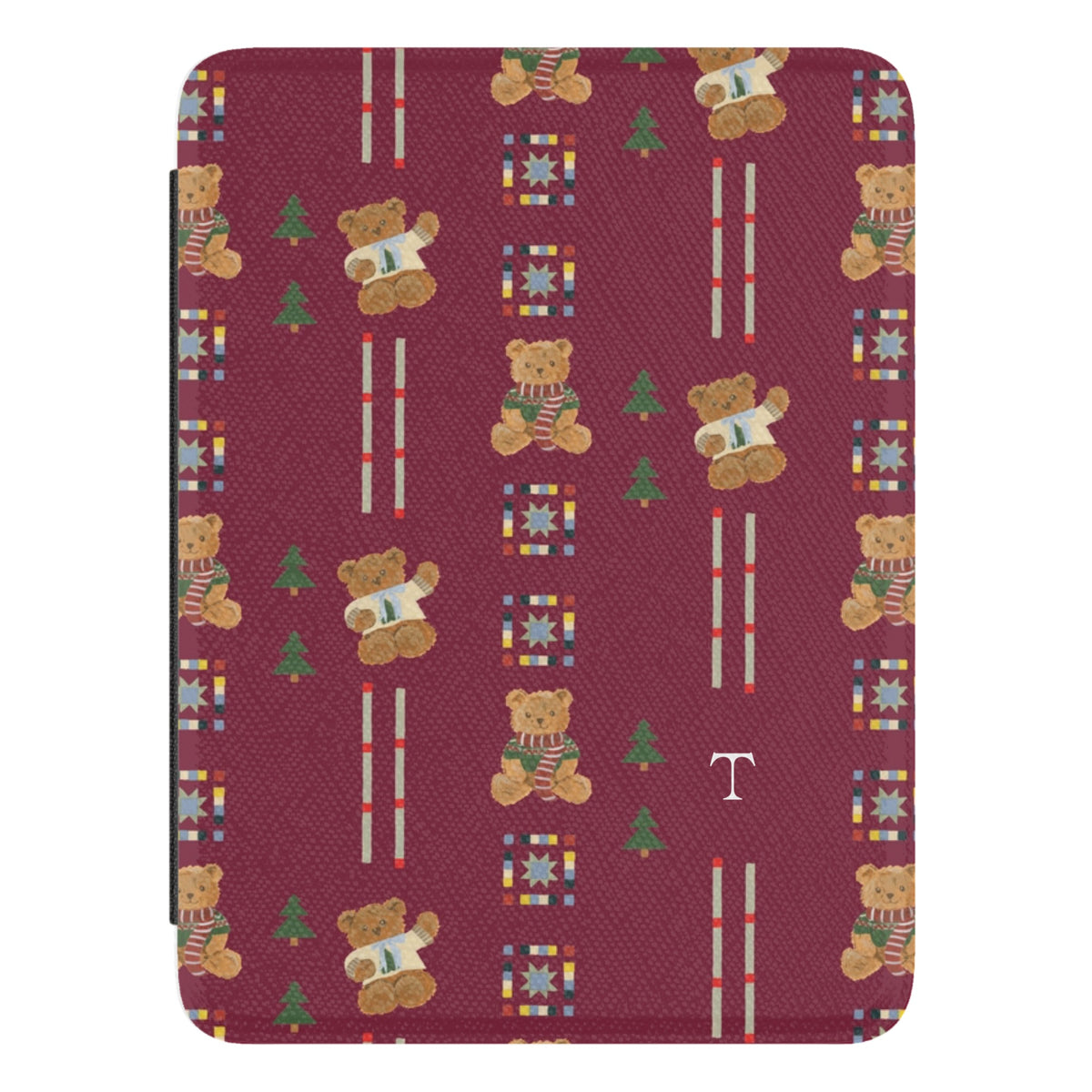 Teddy Personalized Kindle case, close-up of the front: teddy bears in scarves and small pine trees on cranberry red with the initial T