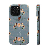 Prairie personalized iPhone case featuring a blue background with horse and floral patterns, and a monogrammed letter "A".