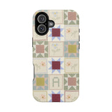 Patchwork personalized iPhone case featuring a colorful quilt design with various geometric patterns and floral accents.