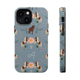 Prairie personalized iPhone case featuring horses, flowers, and a monogram on a blue background.