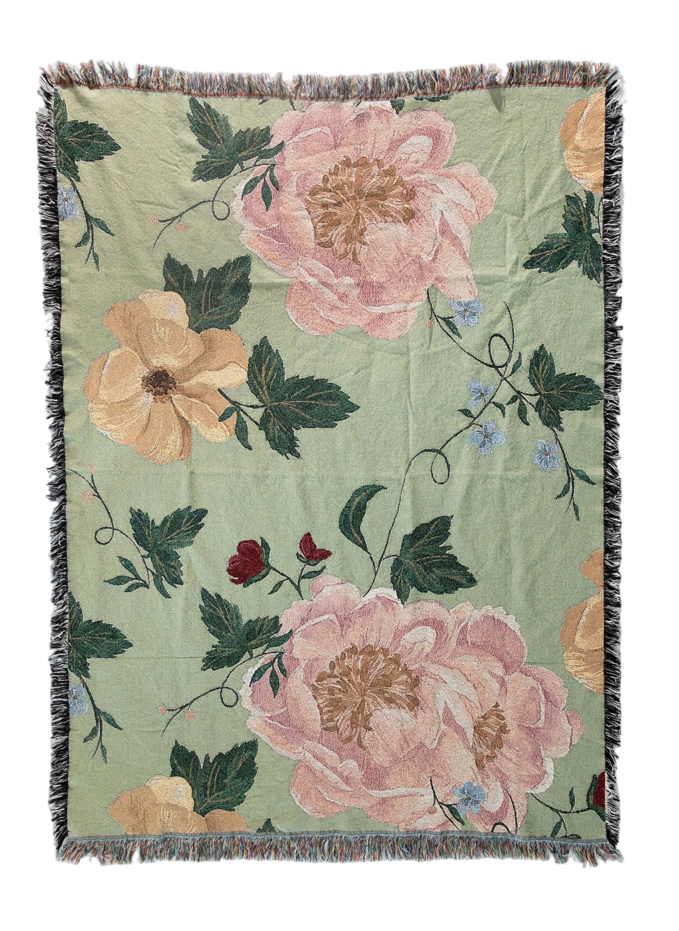 Floral patterned throw blanket with pink and orange flowers on a green background