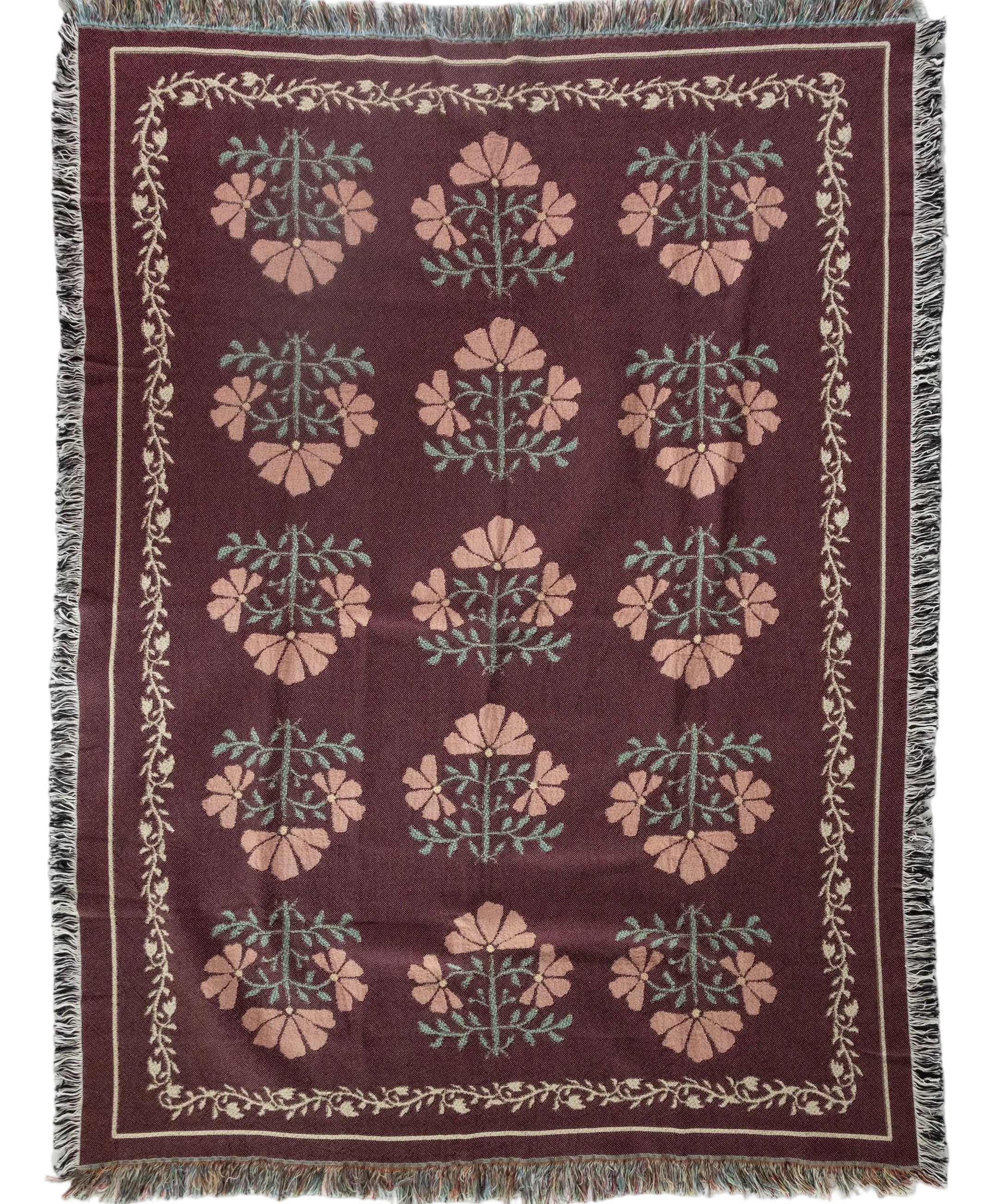 Decorative throw blanket with floral pattern on a white background