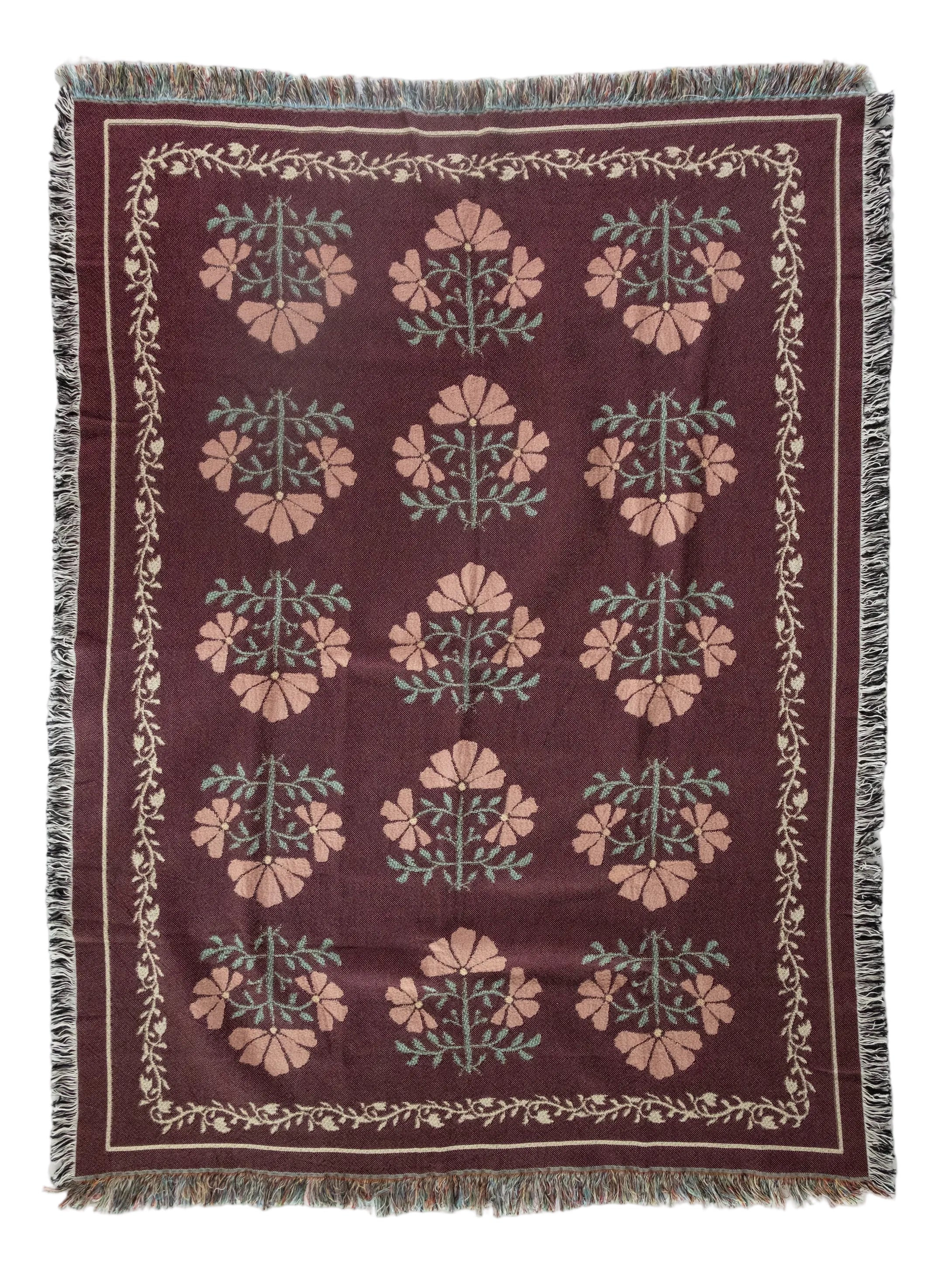 Decorative throw blanket with floral pattern on a white background