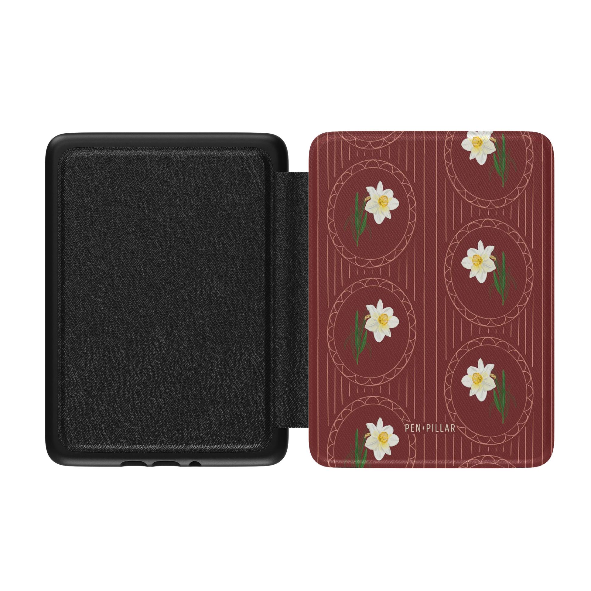 Open black Kindle case with a red floral cover featuring white narcissus flowers in circles and the text PEN+PILLAR.