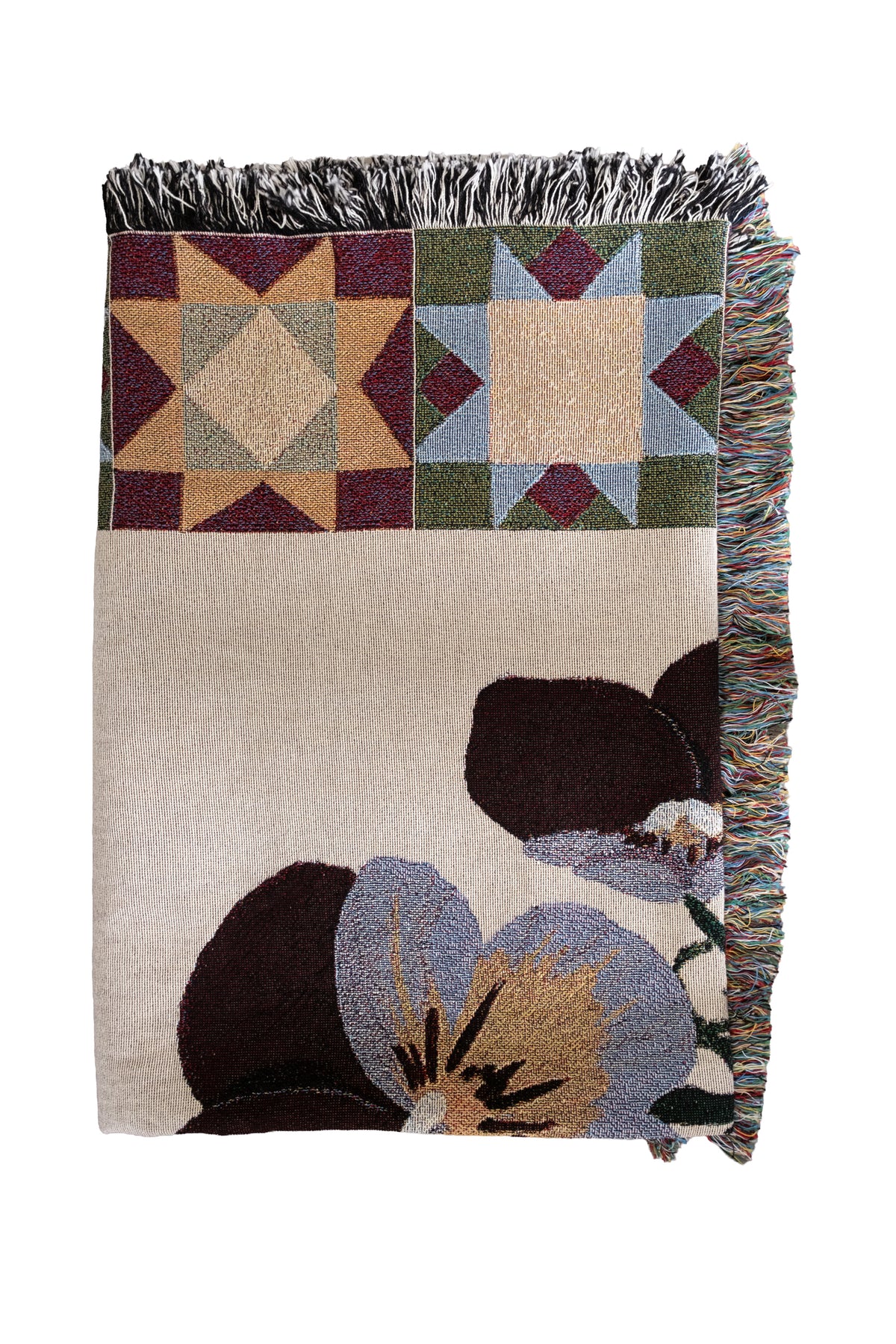 Folded cream woven fabric blanket with fringed edges, featuring purple pansy flowers and geometric star patterns.