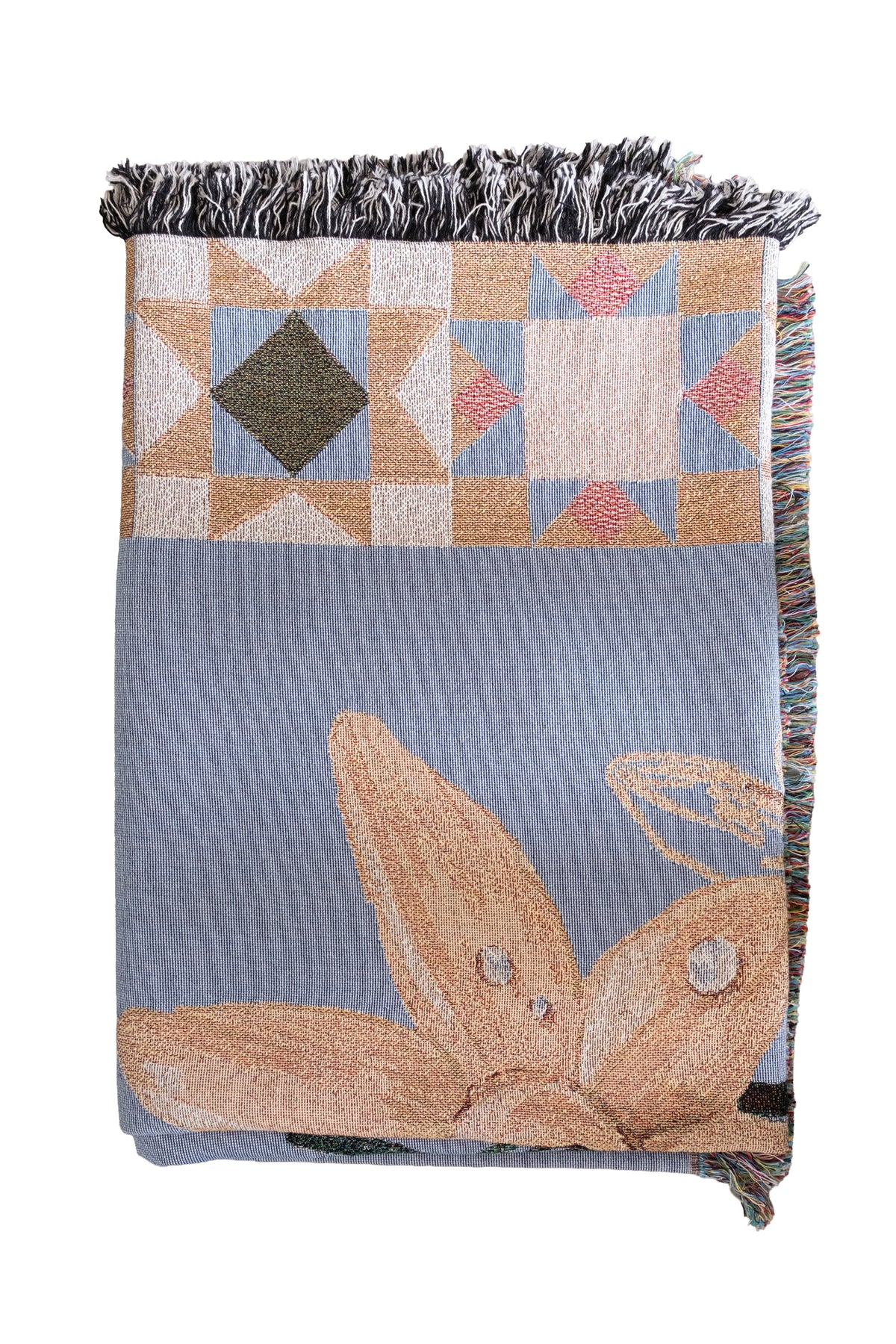 Folded blue woven fabric blanket with fringed edges, featuring a tan floral design and geometric star patterns.