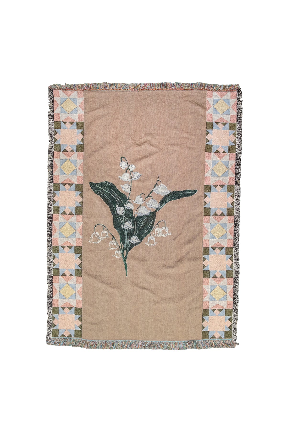 Tan woven blanket with a lily of the valley flower center and geometric star pattern borders.