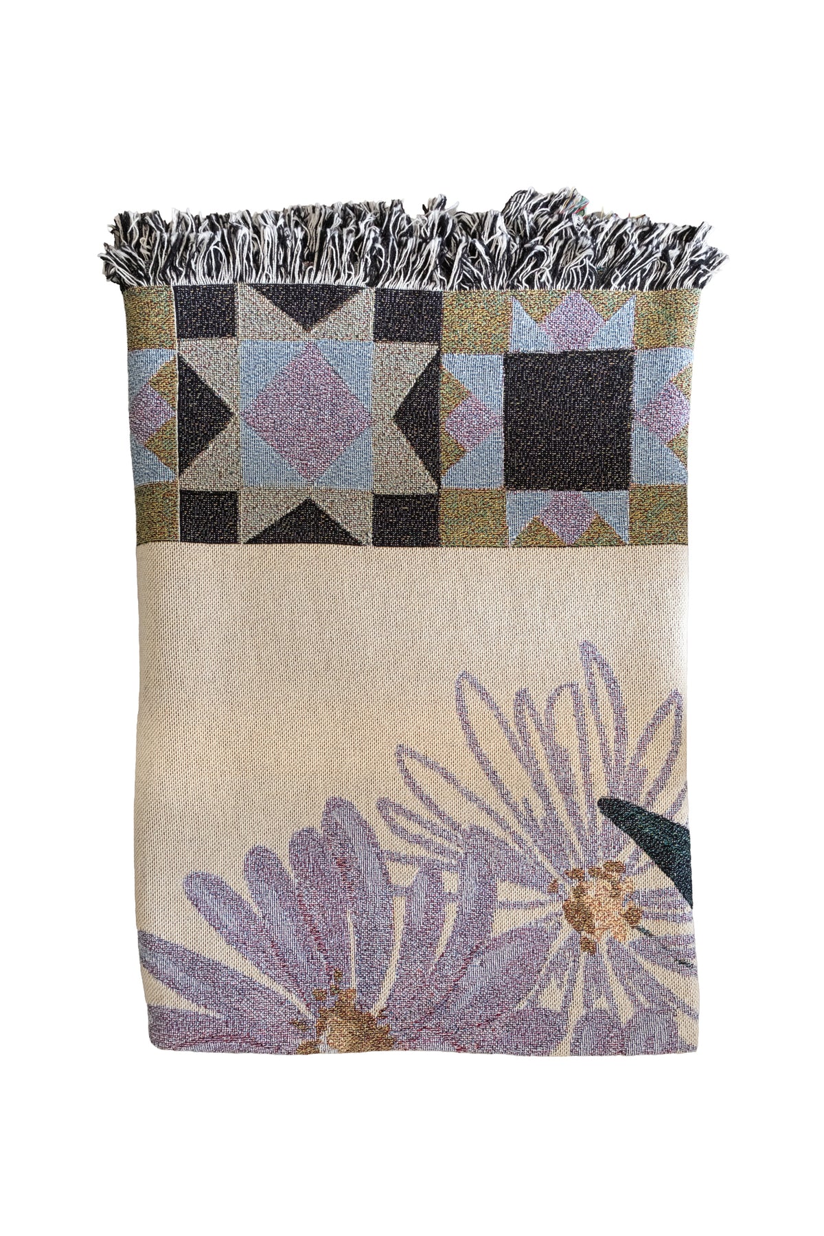 Folded cream woven blanket with purple aster flowers, geometric star patterns, and a fringed edge.