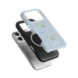 Artichoke iPhone case featuring a light blue floral design, stacked with black and silver cases.