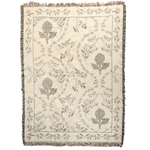 Artichoke woven blanket featuring floral patterns in muted colors with a fringed edge.