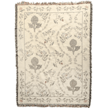 Artichoke woven blanket featuring floral patterns in muted colors with a fringed edge.
