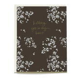 Baby's breath sympathy card with a dark background and gold text saying "holding you in my heart.