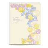 Balloon arch birthday card featuring pastel balloons in yellow, pink, and blue with "Happy Birthday to you" text.