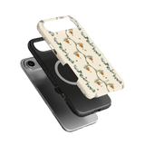 Beehive iPhone case featuring a floral design with bees on a cream background, layered over a black phone case.