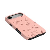 Bike Ride iPhone case featuring a pink background with bicycle and flower illustrations, showing a side angle view.