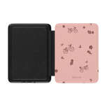 Bike Ride Kindle case featuring a pink exterior with bicycle and flower patterns, black interior, and a magnetic closure.