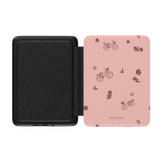 Bike Ride Kindle case featuring a pink exterior with bicycle and flower patterns, black interior, and a magnetic closure.