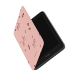 Pink Kindle case with bicycle and flower patterns, partially open to show the device inside.