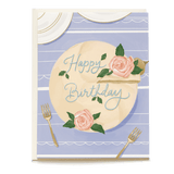 Birthday cake card featuring a pastel cake with pink roses and "Happy Birthday" text on a light blue background.