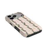 Blackberry iPhone case featuring a floral design with pink roses on a cream background, angled view showing camera cutout.