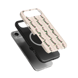 Blackberry iPhone case featuring a floral design on a cream background, layered over a black phone case.