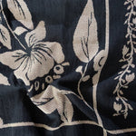 Bramble woven blanket featuring a floral design in cream on a dark navy background.