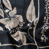 Bramble woven blanket featuring a floral design in cream on a dark navy background.