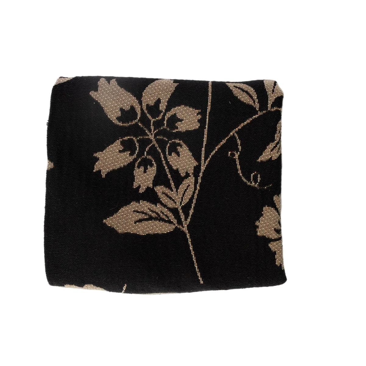Bramble woven blanket featuring a black background with beige floral patterns.