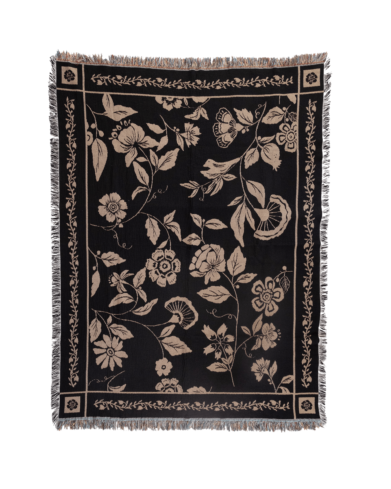 Bramble woven blanket featuring a floral design in cream on a black background with fringed edges.