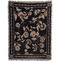 Bramble woven blanket featuring a floral design in cream on a black background with fringed edges.