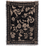 Bramble woven blanket featuring a floral design in cream on a black background with fringed edges.