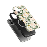 Bumblebee iPhone case featuring floral design with bees, layered over a black protective case on a green background.