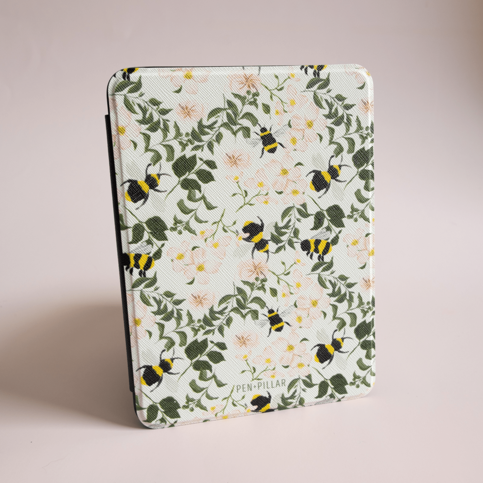 Bumblebee Kindle case featuring a floral pattern with bees on a light green background.
