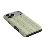 Camellia iPhone case featuring a floral pattern on a light green background with black edges.