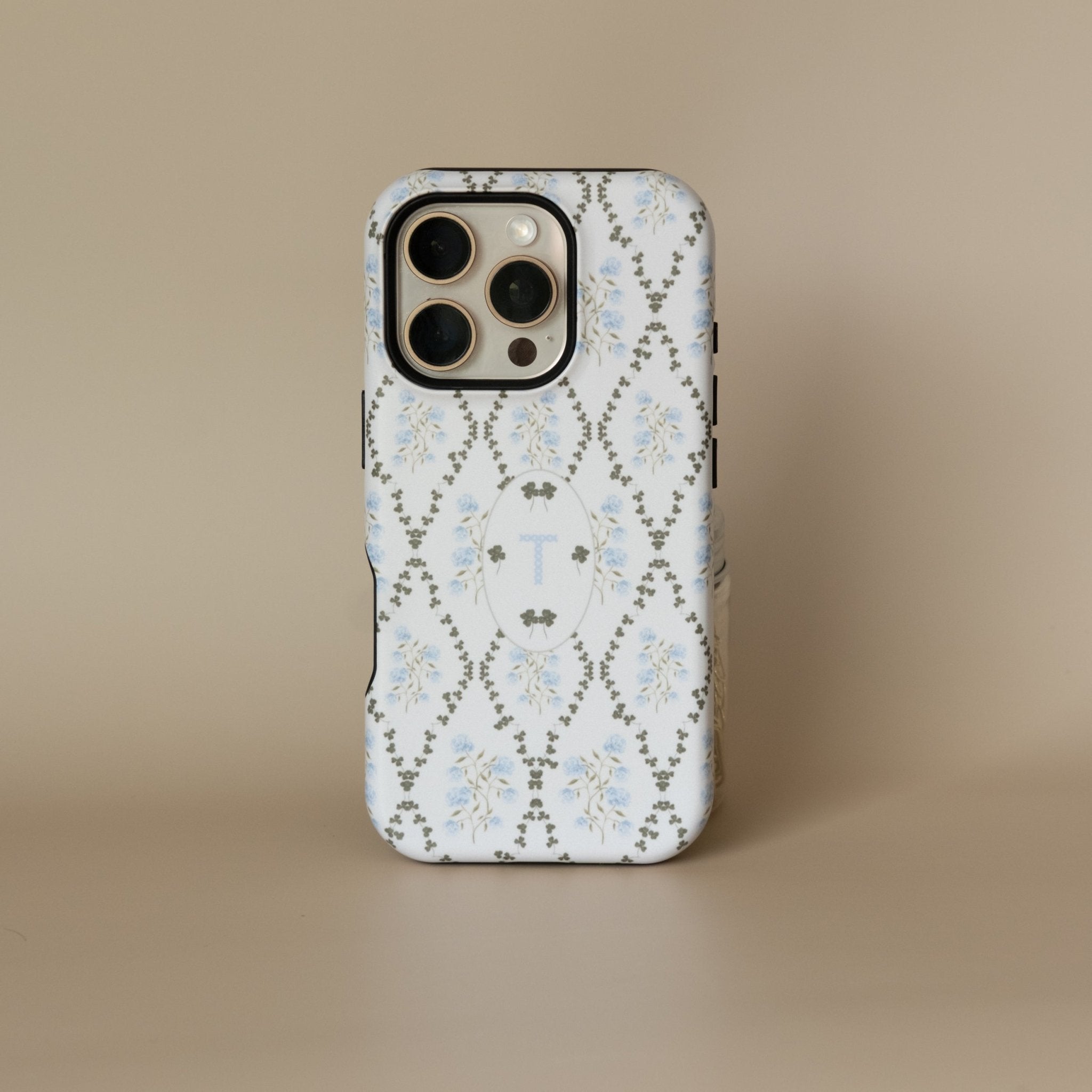 Clover personalized iPhone case featuring a floral design in blue and gray with a monogrammed letter T.