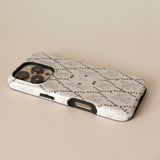 Clover personalized iPhone case with floral design in light colors, showcasing camera cutout and side buttons.