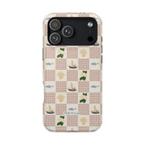 Coastal iPhone case featuring a pattern of sailboats, fish, and greenery on a checkered background.