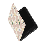 Coastal Kindle case with a checkered pattern featuring boats, flowers, and books in pastel colors.