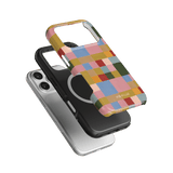 Colorblock iPhone case featuring a multicolored design with squares, layered over a black and silver case.